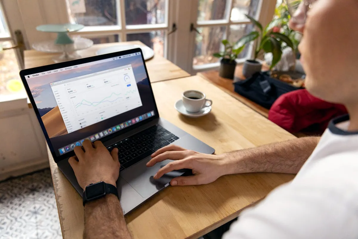 A laptop displaying a Google Analytics dashboard on a desk, used to track where website leads come from