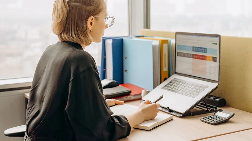 A professional working at a laptop in an office — the credibility customers expect from a real business