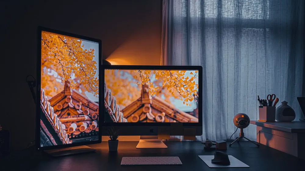 A clean dual-monitor desk setup — your website as your digital headquarters