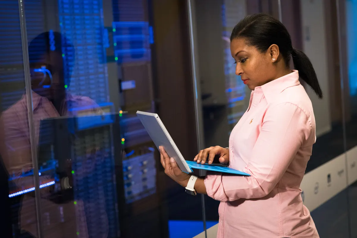 A focused person working on a laptop, representing the process of configuring DNS authentication records