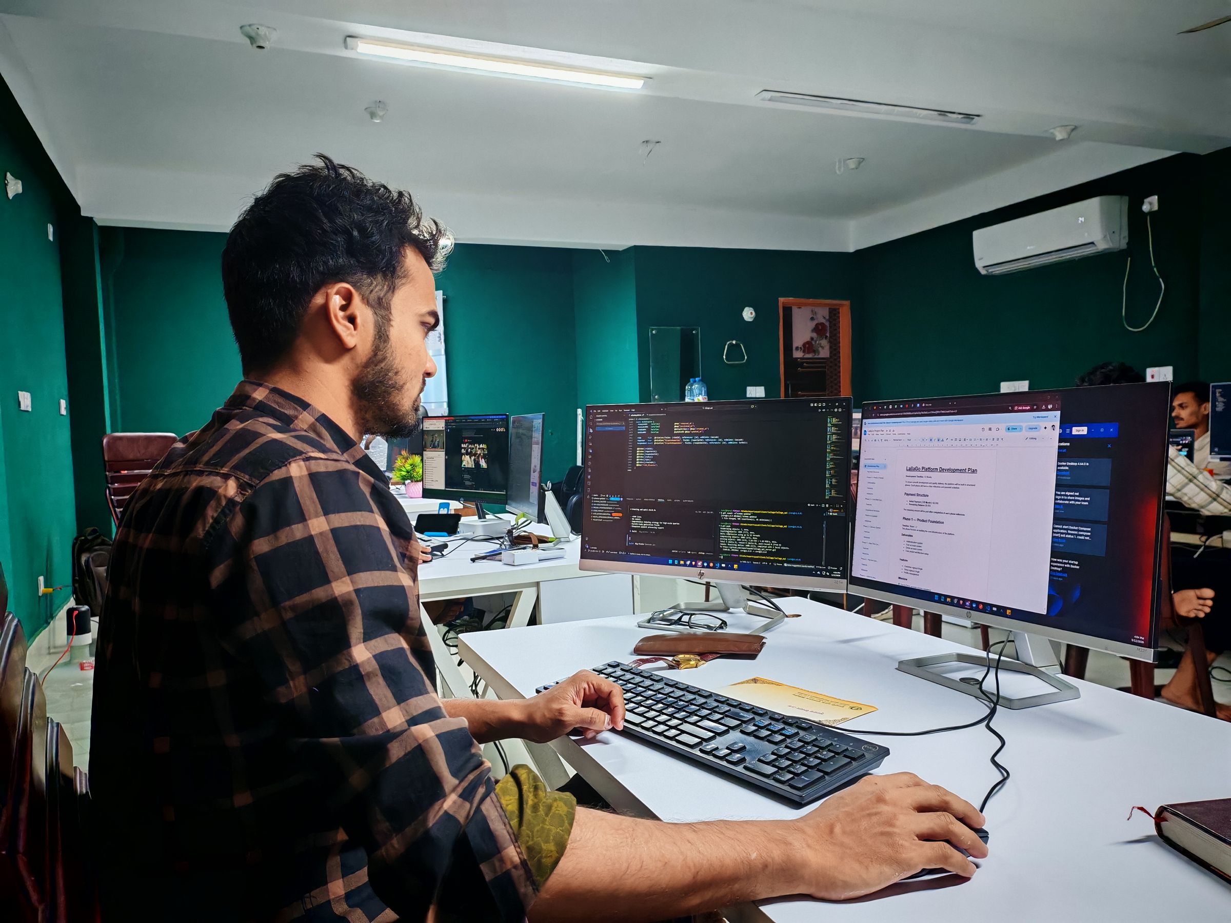 A WordPress and Elementor developer building a custom website layout on a large monitor