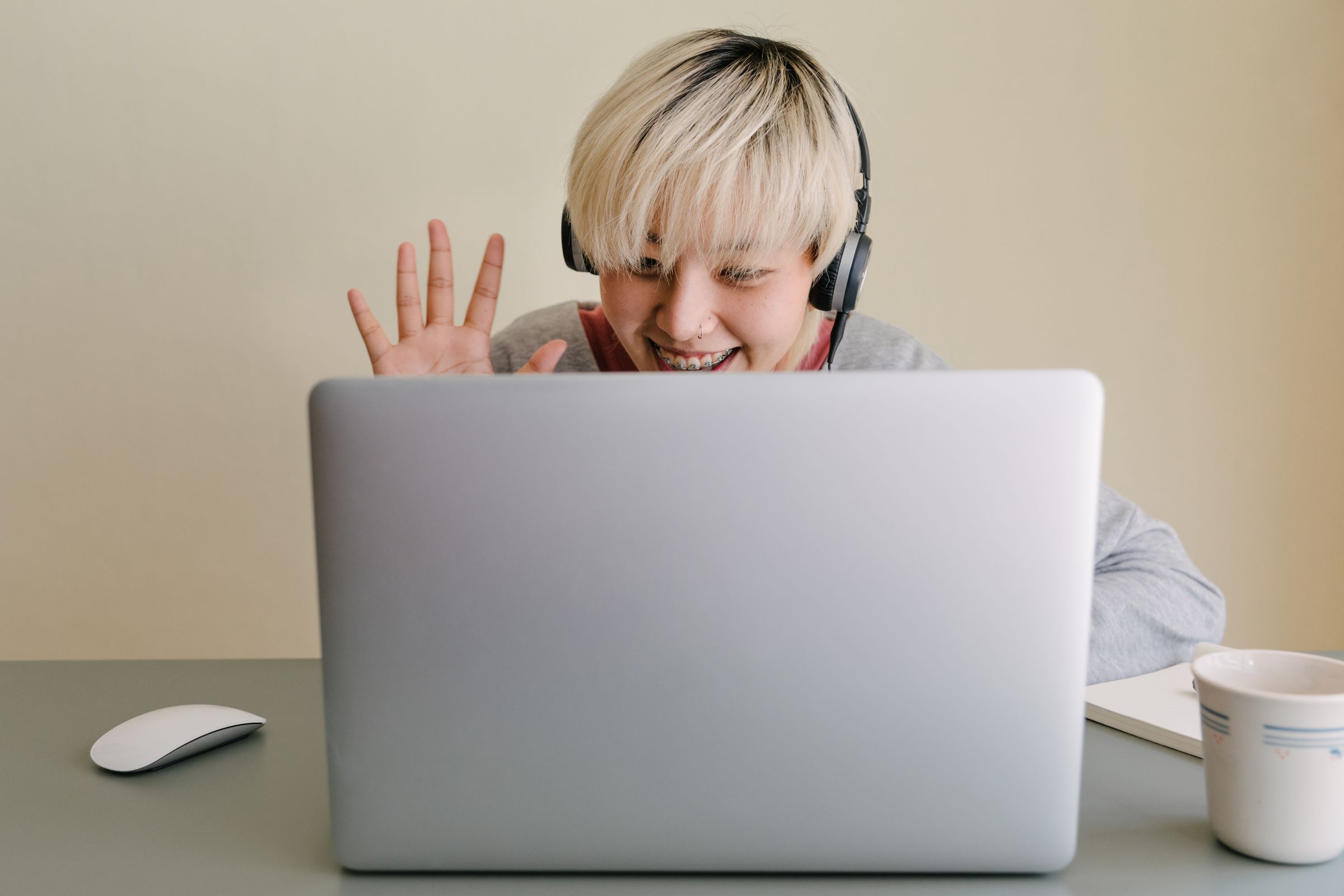 A Filipino developer on a video call with an overseas client, headphones on, smiling