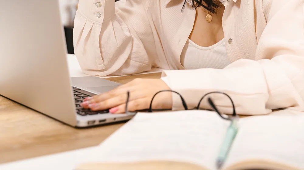 A person sitting at a laptop, a familiar scene whenever a website loads too slowly