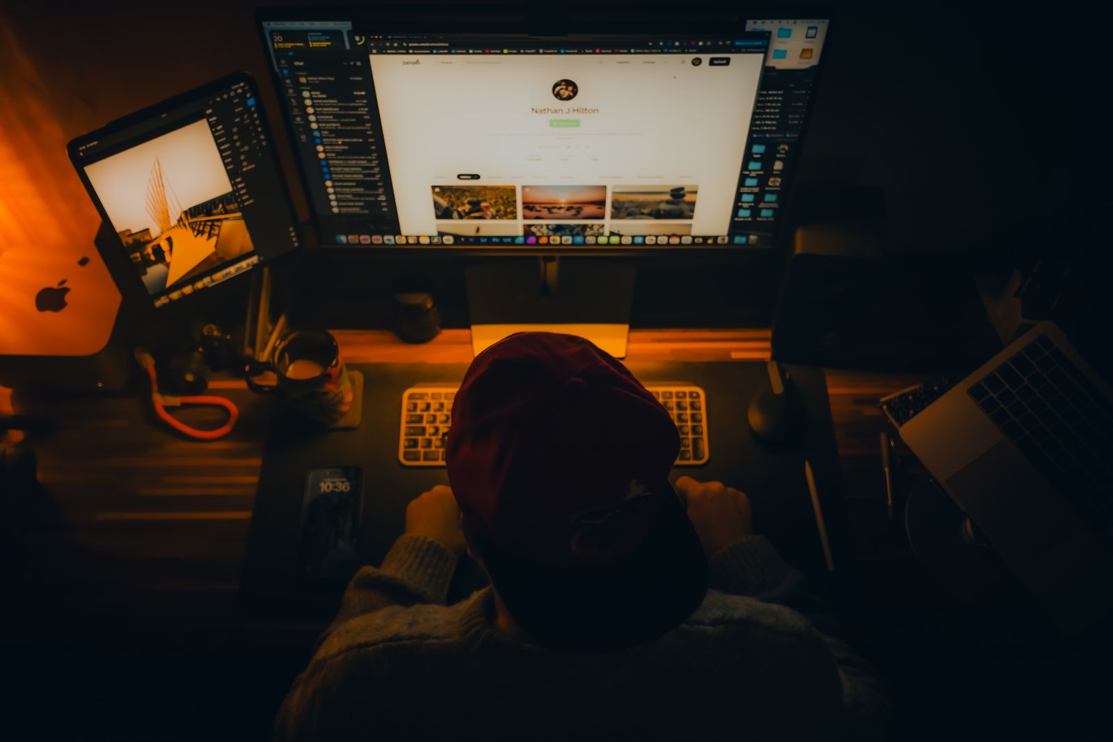 A WordPress developer working at a multi-monitor desk, building a custom website