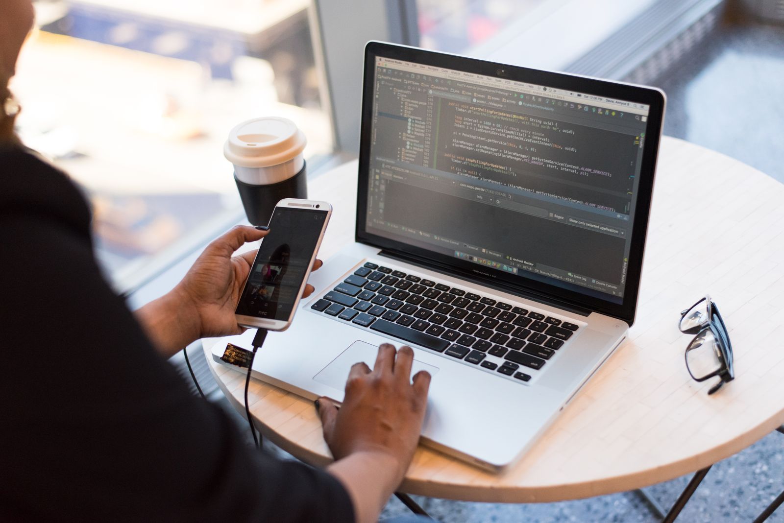 A business owner and developer reviewing a website build together on a laptop